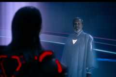 A looming black and red figure faces down glowing white-robed Jeff Bridges in Tron: Ares
